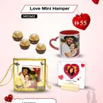 Mini Valentine’s Day love hamper displayed elegantly, featuring a heart-shaped mug with a printed couple photo, a clear acrylic photo frame holding a romantic image, and premium Ferrero Rocher chocolates – a thoughtful personalized gift set.