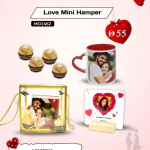 Mini Valentine’s Day love hamper displayed elegantly, featuring a heart-shaped mug with a printed couple photo, a clear acrylic photo frame holding a romantic image, and premium Ferrero Rocher chocolates – a thoughtful personalized gift set.